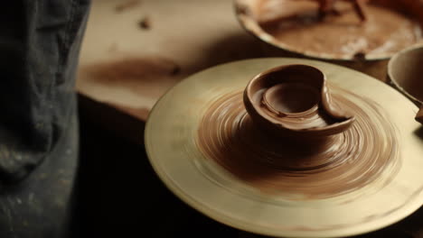 girl moistening hands in pottery. woman getting ready for handmade process