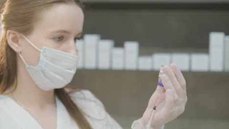 cosmetologist preparing syringe for procedure