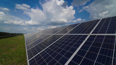 solar panels on a modern electrical station. the clouds are reflected on the surface of the solar panels. alternative clean electricity.