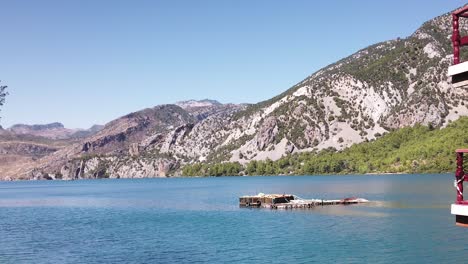 Dock-Tourist-Boat-With-Mountain-Ridge-In-Green-Canyon-Near-Manavgat,-Turkey