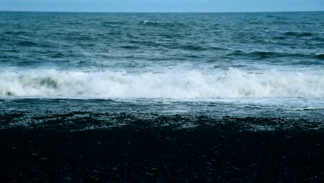 a black sand beach in the icelandic coastline