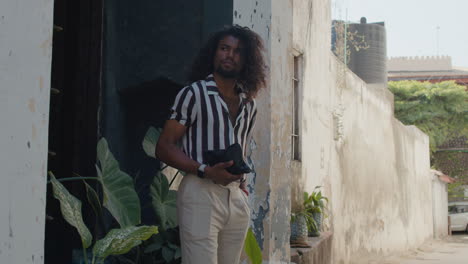 fashionable mixed arabic man walks in the streets of old town