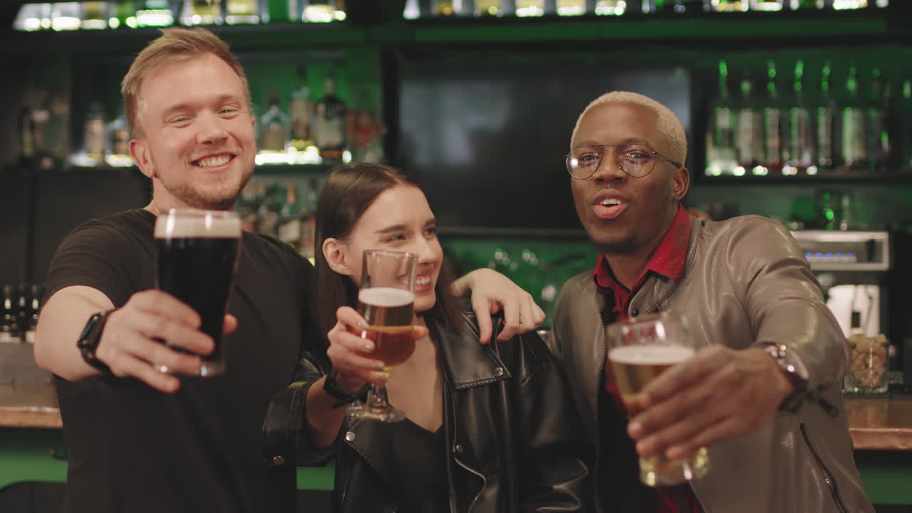 Cheerful Friends With Beer Glasses At Bar