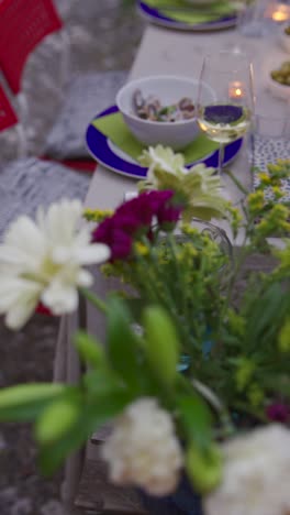 outdoor dinner party with flowers and wine