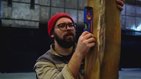 woodworker checking lumber level