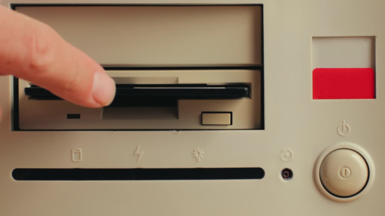 Using diskette for old computer. Music recorder, playing retro computer games. Vintage device for office, obsolete technology. . High quality 4k footage