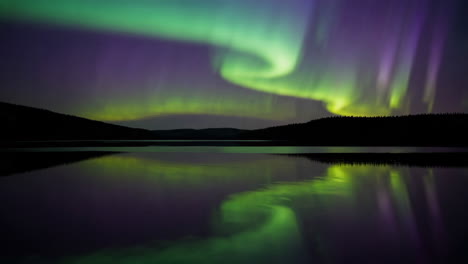 aurora borealis reflected on a lake at night