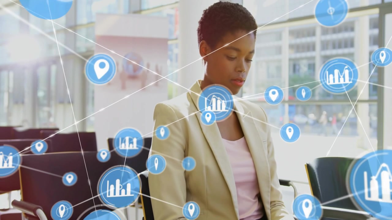 Business woman typing on laptop, initiating blue icons forming network and sweeping across lobby