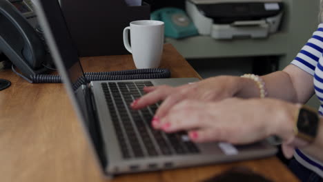 typing on a laptop in an office