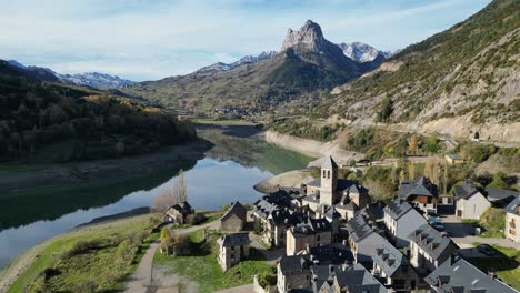 Spanish-Pyrenees,-Sallent-de-Gallego-Village-and-Mountain-Lake---Aerial-4k