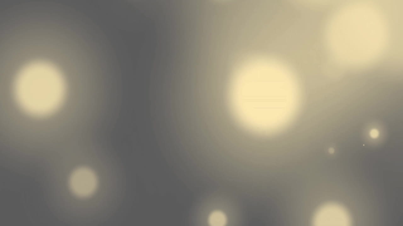 Animation of glowing light spots over grey background