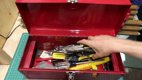 tools being removed from a red toolbox