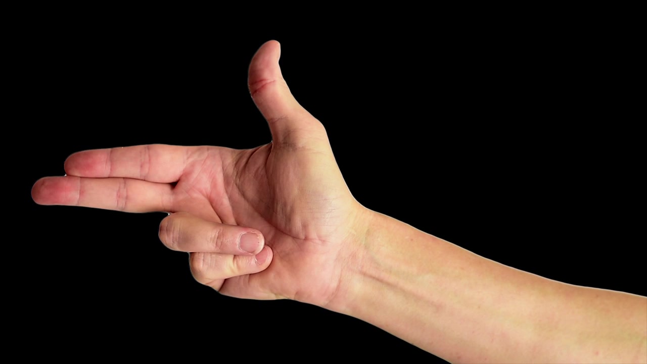 Close up shot of a male hand making the classic fingers gun sign, against a plain black background