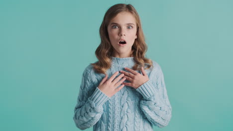 teenage caucasian girl looking amazed in front of the camera.