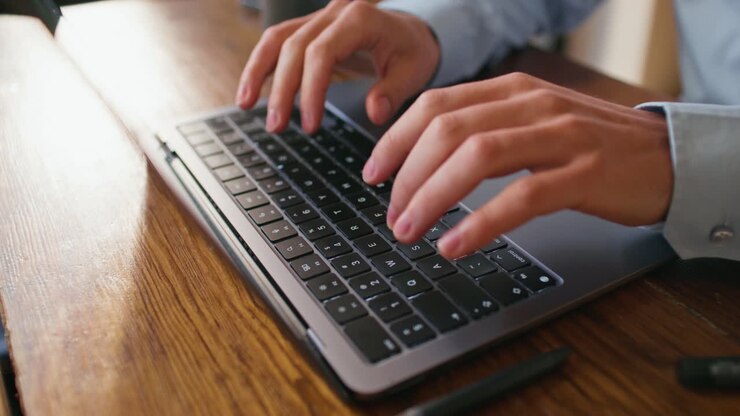 Person Typing on a Laptop