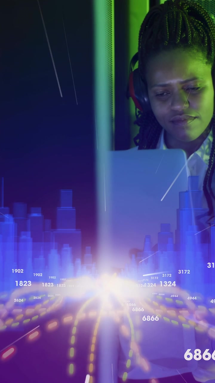 Vertical video: Woman working laptop while bright light casting tech data bars and tracking metrics