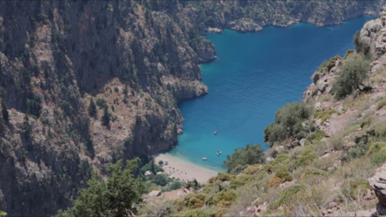 woman make love sign with hand at valley of butterfly