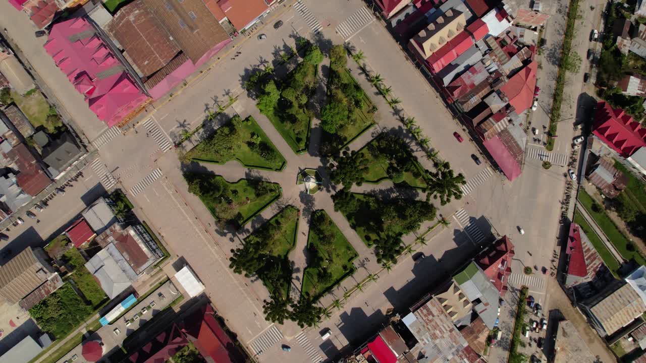 Aerial orbit drone view of a perfect green square in Oxapampa, Peru.