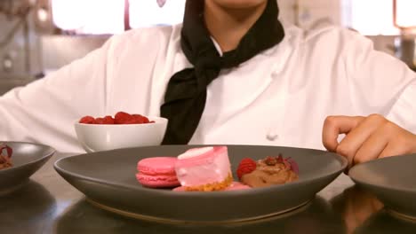 female chef with dessert food on a counter