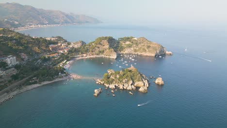 drone flies away from isola bella - top sicilian tourist destination