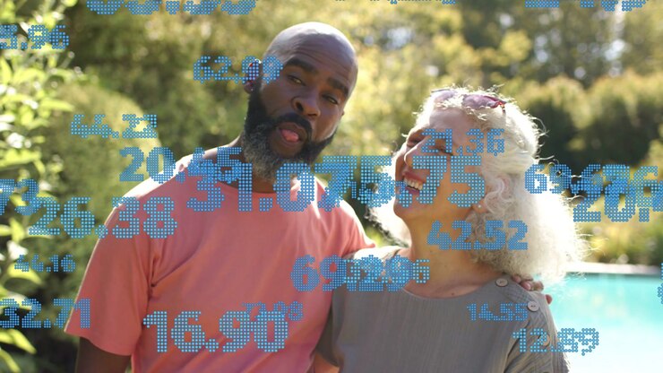 Mature man and woman smiling, showing affection, leaning close by pool with tech numbers drifting