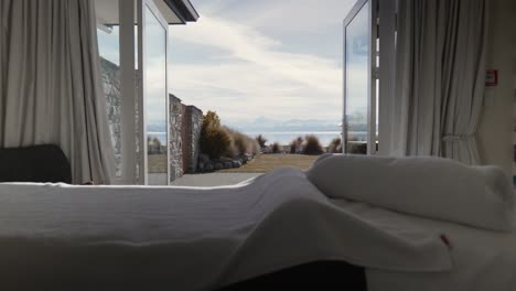 Towels-on-prepared-massage-table-with-spectacular-mountain-view-through-open-glass-doors