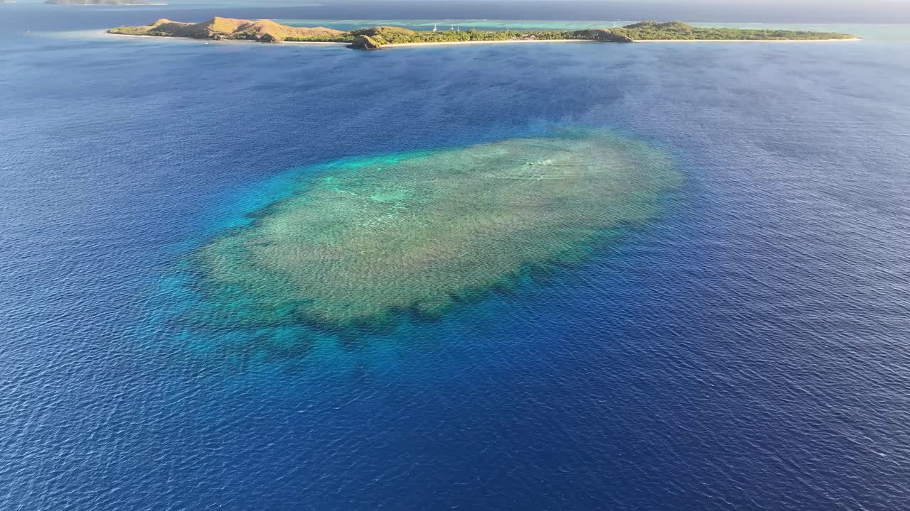 Amazing drone of coral reef by remote tropical Mana Island, Fiji. Exotic holiday, diving destination.