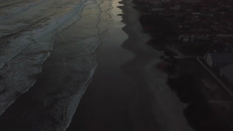 flying shot of drone going through palms and beach in sunrise-sunset, establishing aerial shot