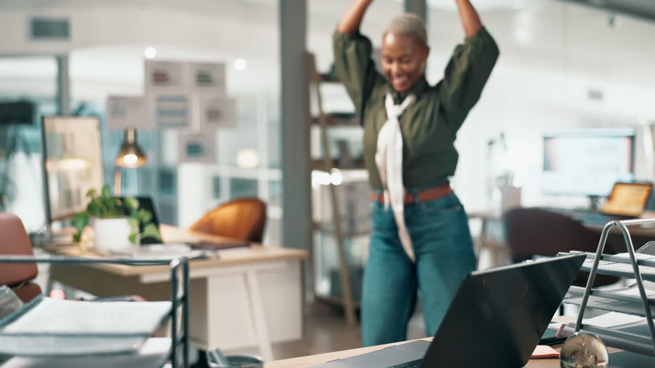 Woman celebrating success in office