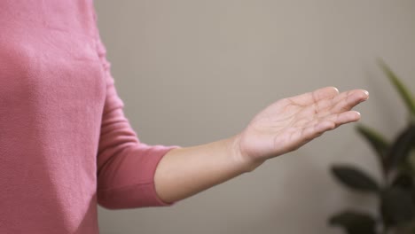 woman sanitizing hands with alcohol spray