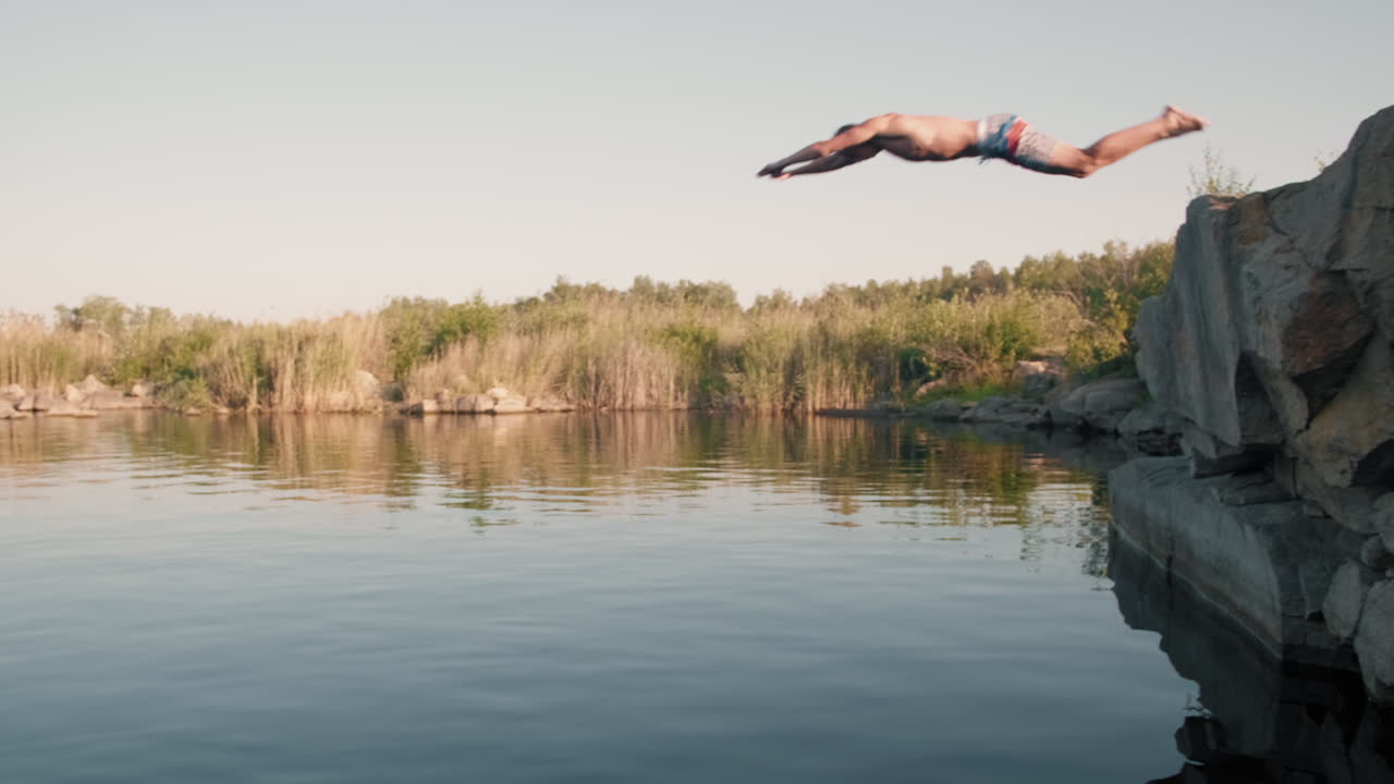 Young Man Diving into Lake