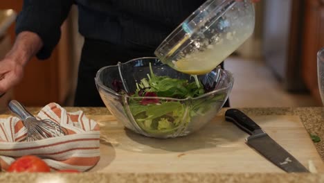 making salad dressing and tossing salad