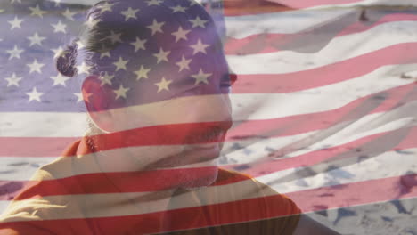 animación de la bandera de los estados unidos de américa sobre el hombre mayor en la playa