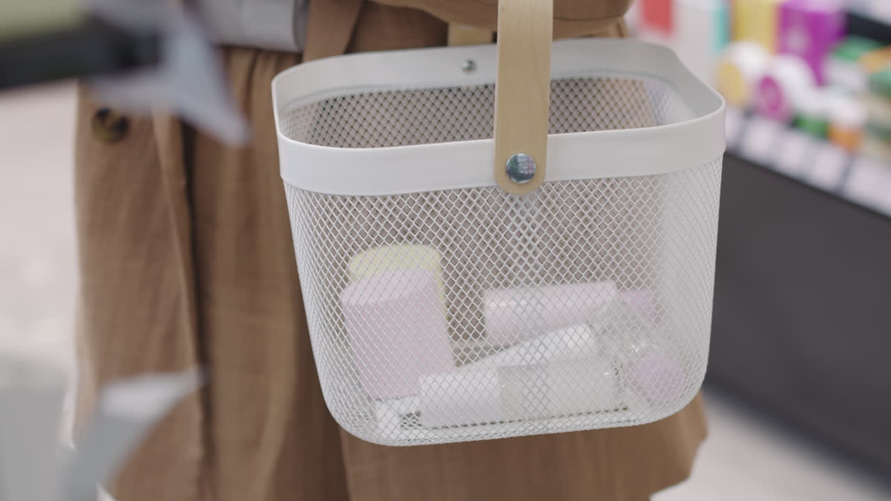 Woman Putting Beauty Products In Shopping Basket