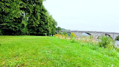 lush greenery and historic stone bridge view