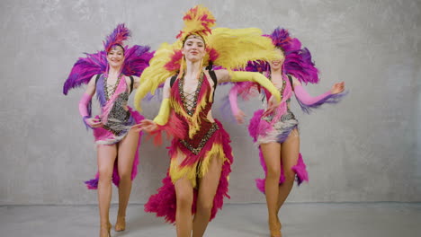 three beautiful showgirls dancing