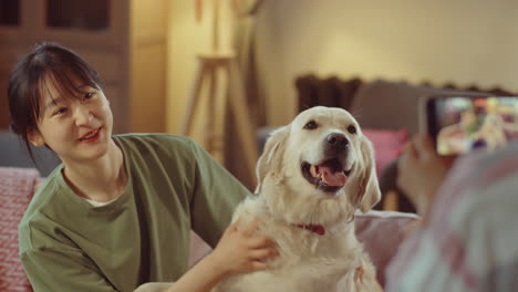 smiling asian woman posing with dog for photo