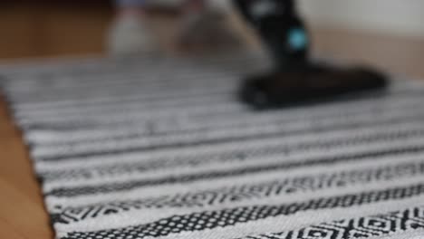 unrecognizable-woman-mopping-the-hardwood-floor-in-the-living-room