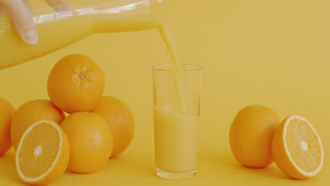 pouring orange juice into a glass