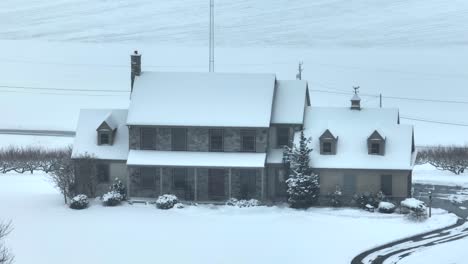 aerial view of a snow-covered house on a hill