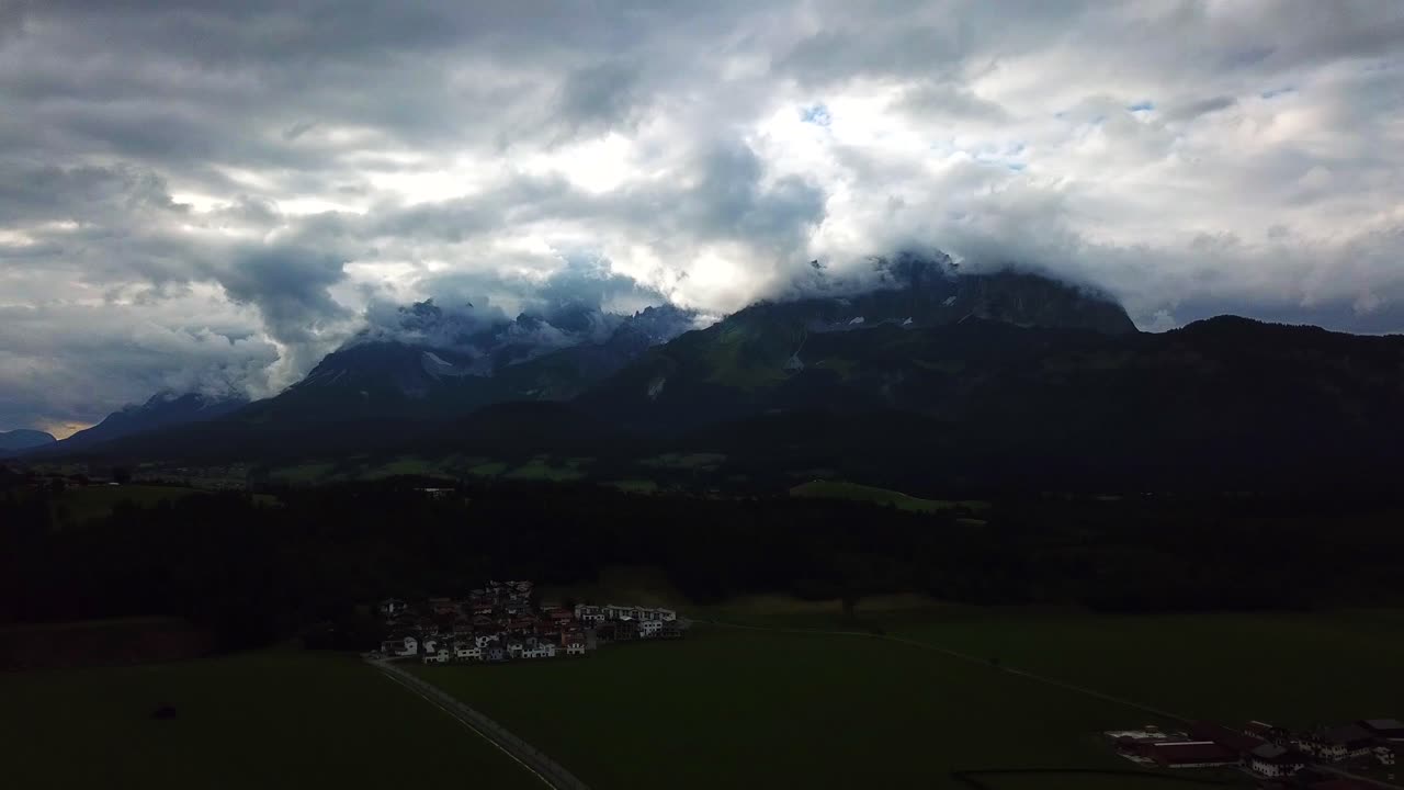 Aerial shot above a mountain valley and a stormy cloudscape, Oberndorf, Austria