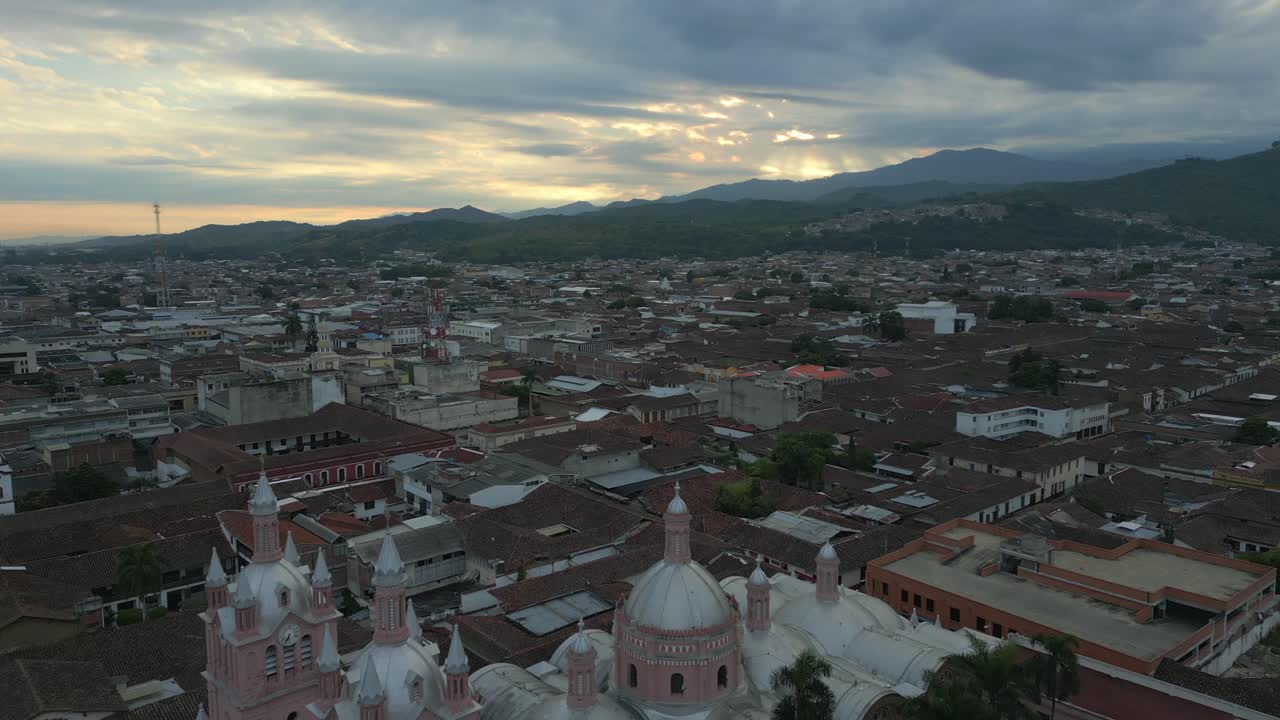Aerial View of a Historic City with a Pink Church at Sunset