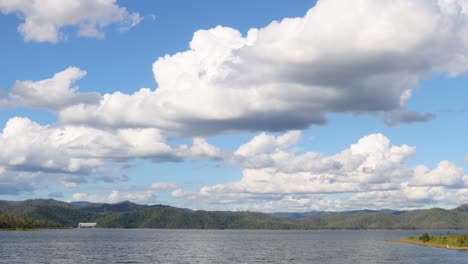 clouds drift over a tranquil lake and hills