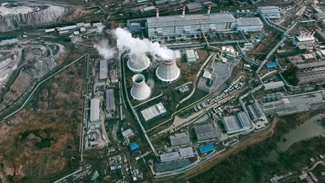 aerial view of industrial zone with factories expelling smoke around a green landscape 1