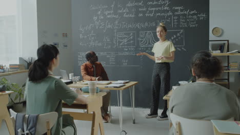 students and professor in a university classroom lecture
