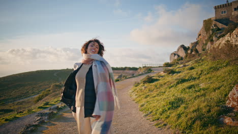 joyful tourist exploring nature landscape feeling freedom at scenic backdrop.