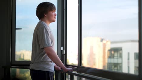 teenager looking out of a window