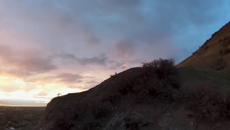 FPV-aerial-view-reveals-the-Utah-Valley-at-sunset-behind-the-great-Wasatch-Mountain-in-Slate-Canyon-in-Provo-Utah
