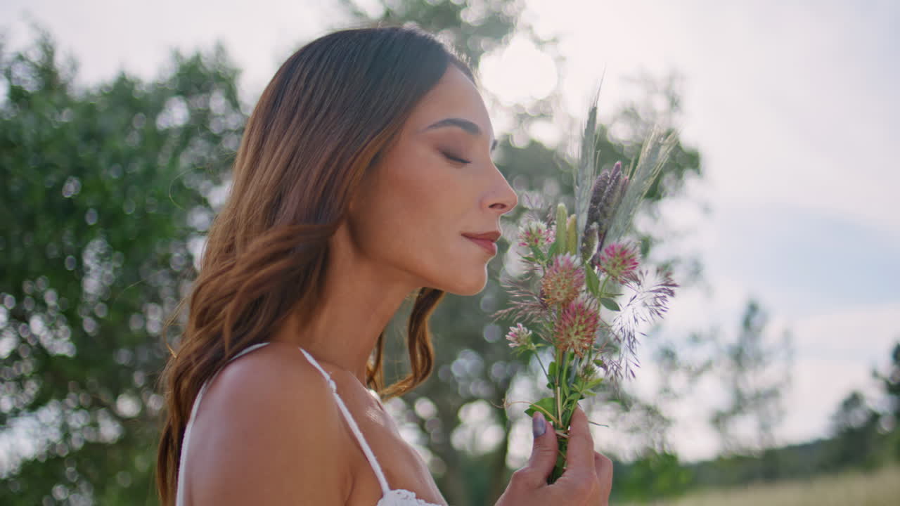 Portrait countryside model flowers in rural nature. Woman wildflowers bouquet