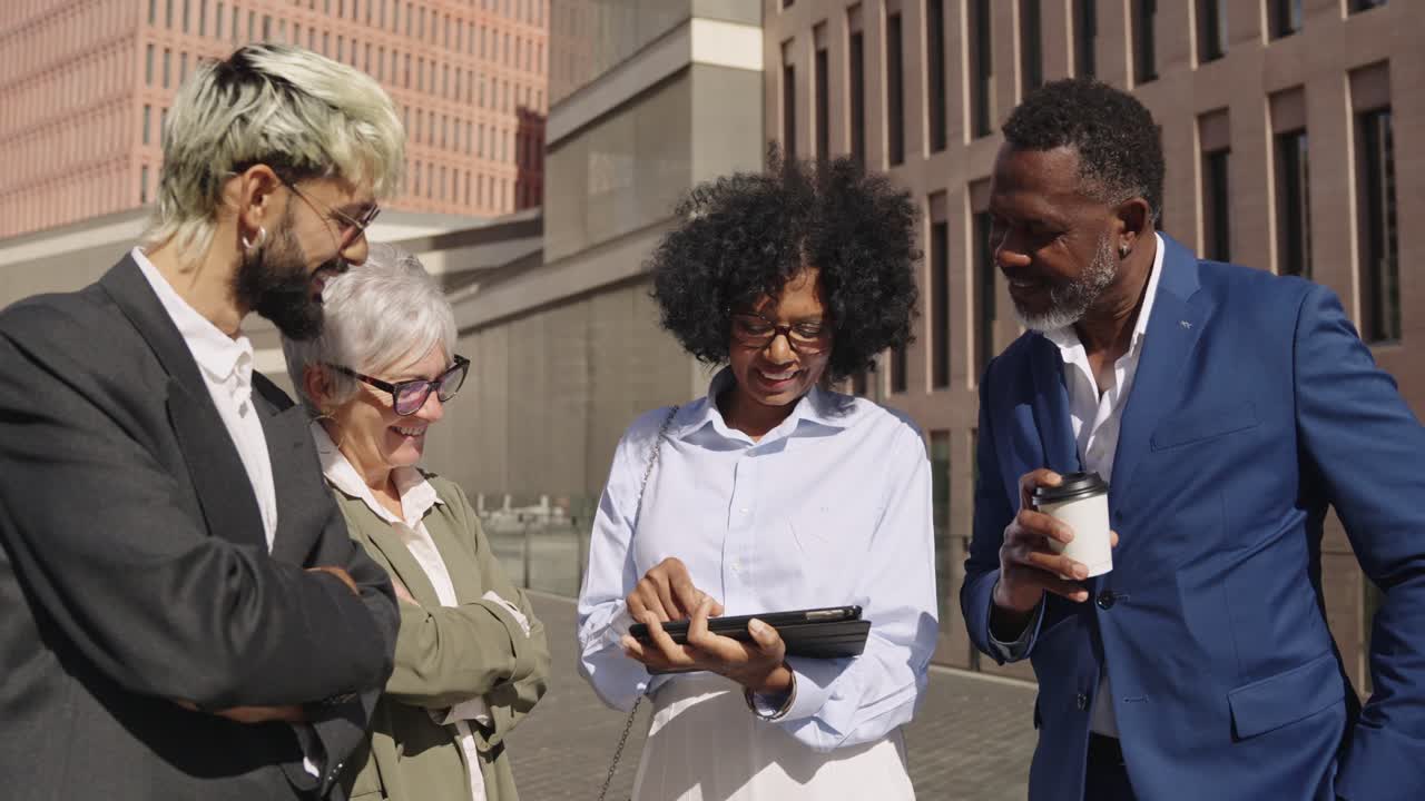 Business people outside using a tablet